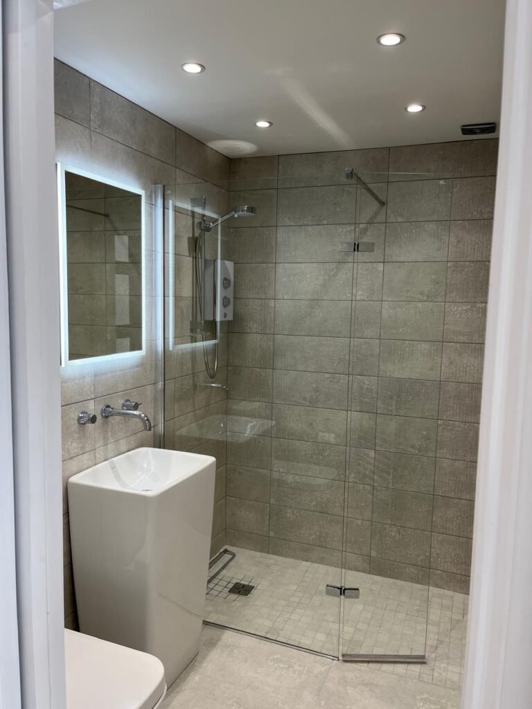 Modern tiled bathroom with walk-in shower in refurbished Bournemouth flat